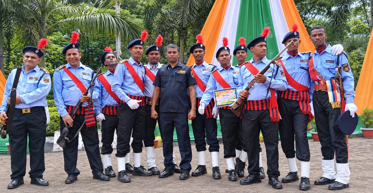 Uniformed security personnel assembled with a rifle-bearing guard